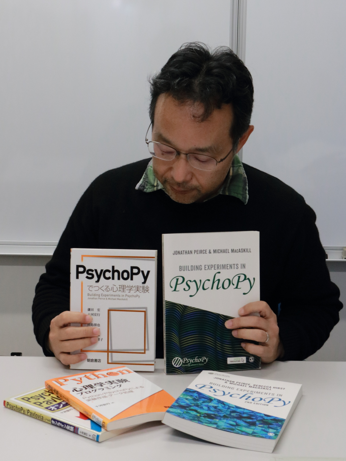 Hiroyuki with the translated version of the book, Building Experiments in PsychoPy.